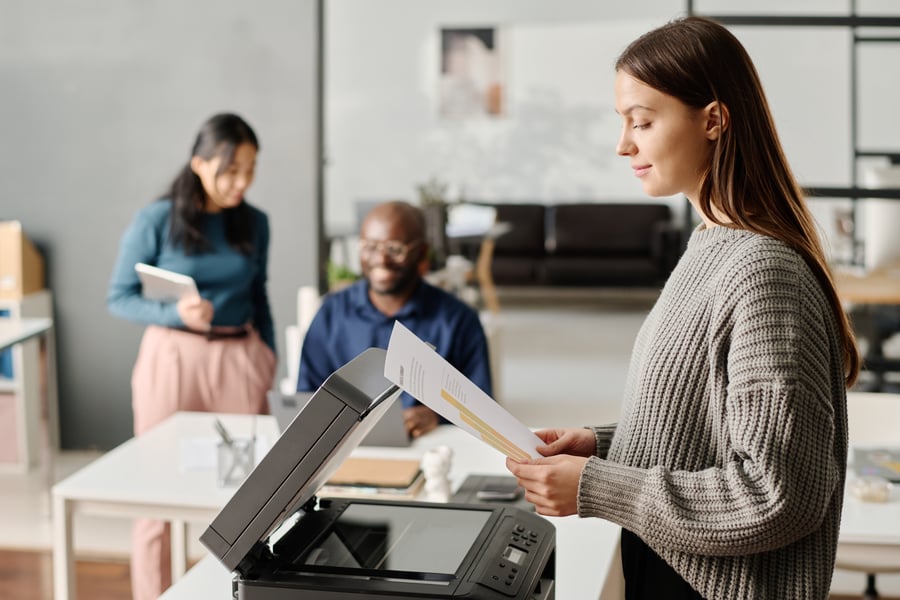 woman standing at printer